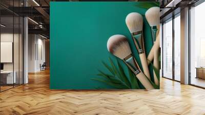 Soft natural brushes for makeup application on green background with copy space Wall mural