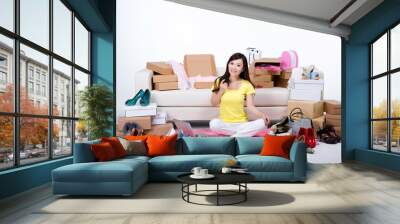 Shed on young woman sitting on the ground using laptops online shopping Wall mural