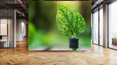 A green electric plug and leaf represent a sustainable way of living that protects the environment. This idea is connected to ESG, which stands for environmental, social, and governance factors. Wall mural