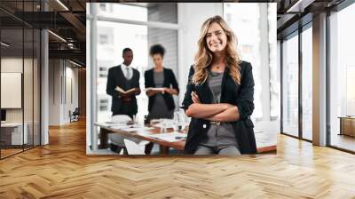 Crossed arms, smile and portrait of businesswoman with people in office for leadership in career. Confident, happy and female manager with team of financial advisors for pride of job in workplace. Wall mural