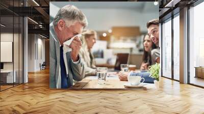 Business, man and sick with allergy in meeting blowing nose on tissue, cold and flu of staff in office workplace. Male, person and sneeze from virus, bacteria and health safety with burnout risk Wall mural