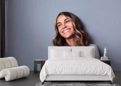 Beautiful smiling woman studio shot on gray background. Wall mural