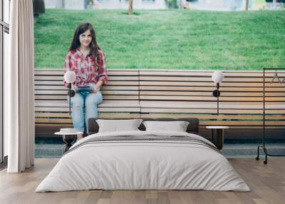 Girl with tablet sitting on the bench. Wall mural