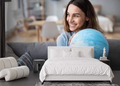 Portrait of a beautiful happy woman with a globe indoors. Wall mural