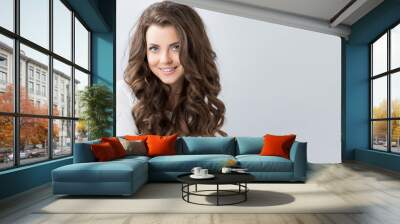 Portrait of a beautiful young woman with wavy hair. Wall mural