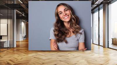 Smiling girl with wavy long hair. Portrait happy woman. Wall mural