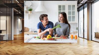 Young couple in the kitchen while preparing a vegetarian breakfast. Healthy eating Wall mural