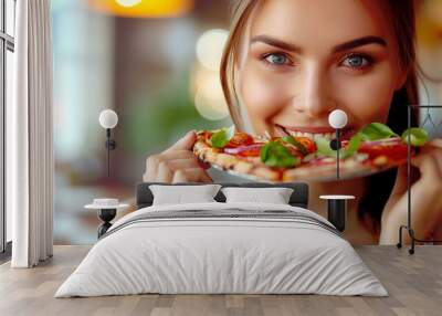 Portrait of a beautiful young woman eating pizza with a bokeh background and focus on her face with a happy smiling Wall mural