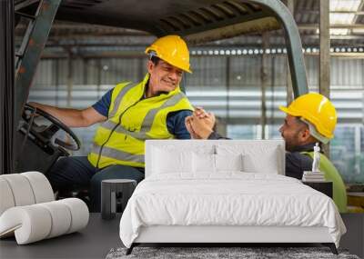 greeting by handshake touch fist and elbow of two engineer supervisor partnership in old factory. foreman greeting friend for good friendship colleague laborer in teamwork factory. Wall mural