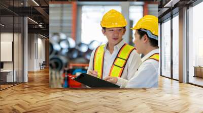 Man mentor teaching male young employees trainee operating machine look monitor and check Production process machinery. foreman explaining man engineer control heavy machine metal sheet steel. Wall mural