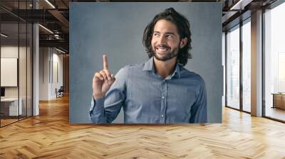 Studio, thinking and business man with pointing for announcement, promotion and smile with pride. Professional career, sales assistant and hand gesture for marketing deal, choice and gray background Wall mural