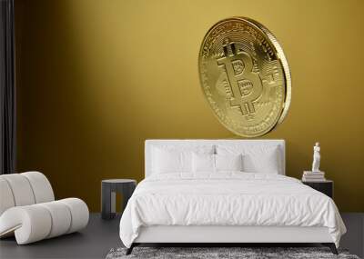 One bitcoin golden coin reflection stock images. Cryptocurrency isolated on a golden background with copy space for text. Digital gold images. Beautiful gold bitcoin coin photo images Wall mural