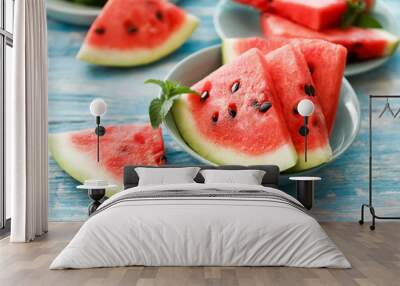 Close-up of fresh red watermelon slices in blue plate on an blue rustic wooden background. Wall mural