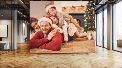 Christmas, portrait and happy family in home on floor, bonding and together. Xmas, smile and face of parents with children, interracial and African mom with father for party, celebration or holiday Wall mural