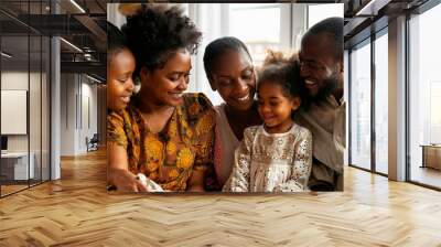 A family of four, including a young girl, are sitting together and smiling Wall mural