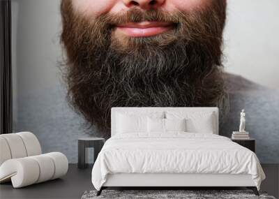 Portrait. The man with the thick beard smiles. Wall mural