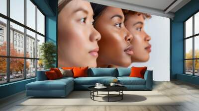 Three diverse women in profile against a white background. The image highlights beauty and unity Wall mural