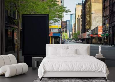 Urban city street view with a large black empty billboard in the foreground. The background shows a quiet street lined with buildings. Ideal for copy space and advertising mockup purposes. Wall mural