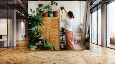 woman watering plants on the balcony Wall mural