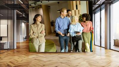 Collaborative team walks through the modern office space, sharing ideas and laughter Wall mural