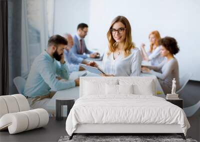 elegant businesswoman standing in office with digital tablet Wall mural