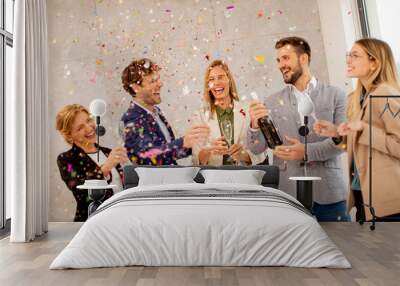 Group of business people celebrating and toasting with confetti falling in the office Wall mural