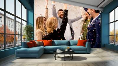 Group of business people celebrating and toasting with confetti falling in the office Wall mural