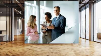 Group of business people using digital tablet at meeting in the office Wall mural