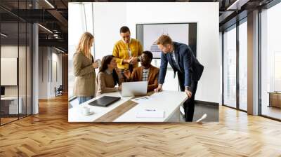 Group of multiethnic business people working together and preparing new project on a meeting in office Wall mural