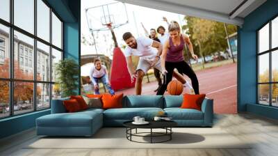 Group of multiethnic people  playing basketball on court Wall mural