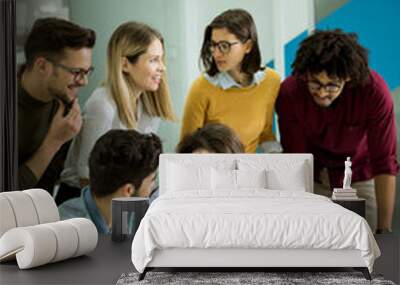 Group of young multiethnic business people working and communicating together in creative office Wall mural