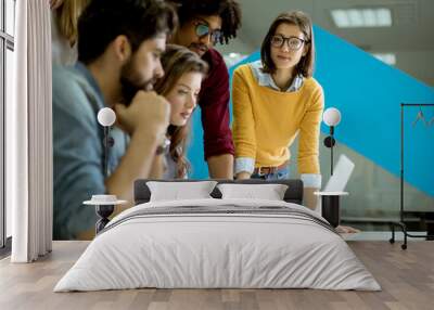 Group of young multiethnic business people working and communicating together in creative office Wall mural