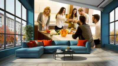 Group of young people having dinner and drinking wine in modern Wall mural