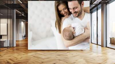 Happy family with newborn baby Wall mural