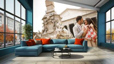 Happy loving couple, man and woman traveling on holidays in Rome, Italy Wall mural