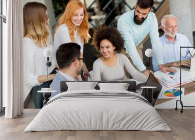 Joyful multiracial business team at work in modern office Wall mural