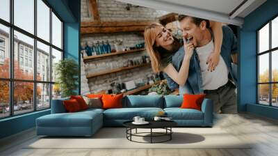 Lovely couple having fun together at rustic kitchen Wall mural