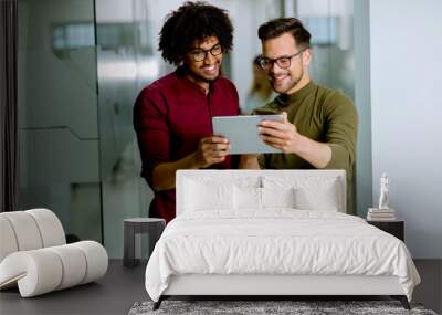 Multiethnic business partners using a digital tablet in the office Wall mural