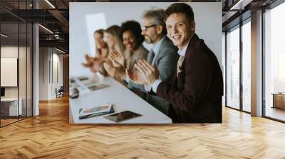 Multiethnic group of business people working together and applauding in after succesful meeting in office Wall mural