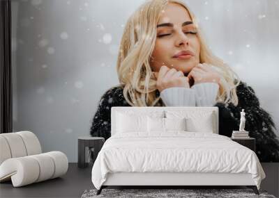 Pretty young blonde woman at winter day Wall mural