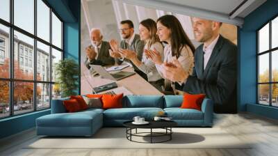 Satisfied proud business team clapping hands Wall mural