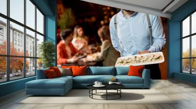 Waiter carrying plate with meat dish in the restaurant Wall mural