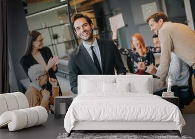 Young businessman using digital tablet in office Wall mural