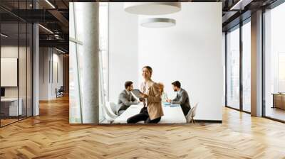 Young businesswoman using digital tablet in a modern office Wall mural