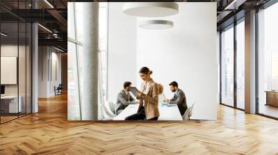 Young businesswoman using digital tablet in a modern office Wall mural