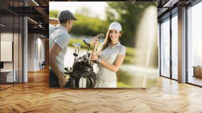 Young couple at golf court Wall mural