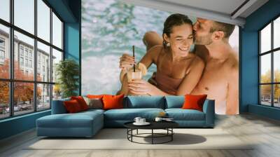 Young couple relaxing by the indoor swimming pool Wall mural