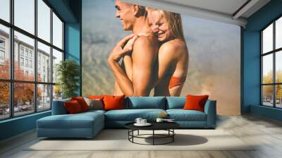 Young couple relaxing on the beach Wall mural