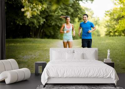 Young couple running Wall mural