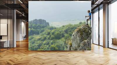 Young man hiking on the mountain Wall mural